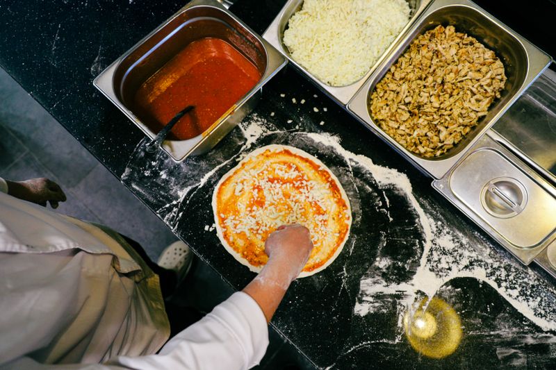 Fresh margherita pizza slice with basil and mozzarella at Jet's pizza